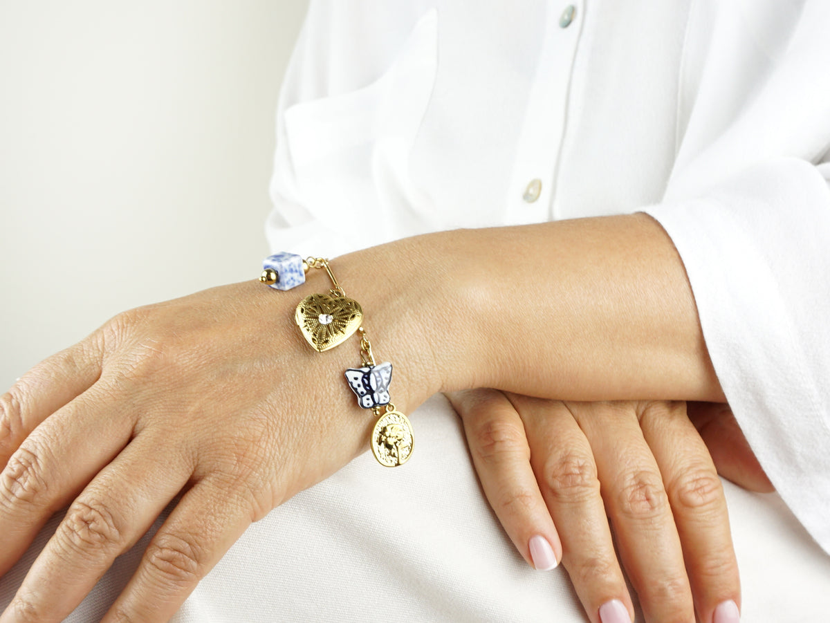 Pulseira de Berloques Tons Azuis, Inspirado na Filigrana Portuguesa, Aço Inoxidável Dourado - Pormenor Mulher a usar Pulseira